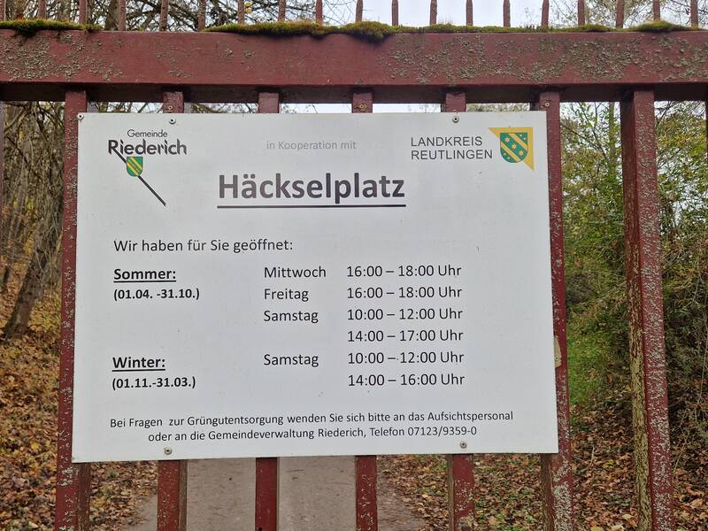 Ein Schild mit den Öffnungszeiten des Häckselplatzes der Gemeinde Riederich